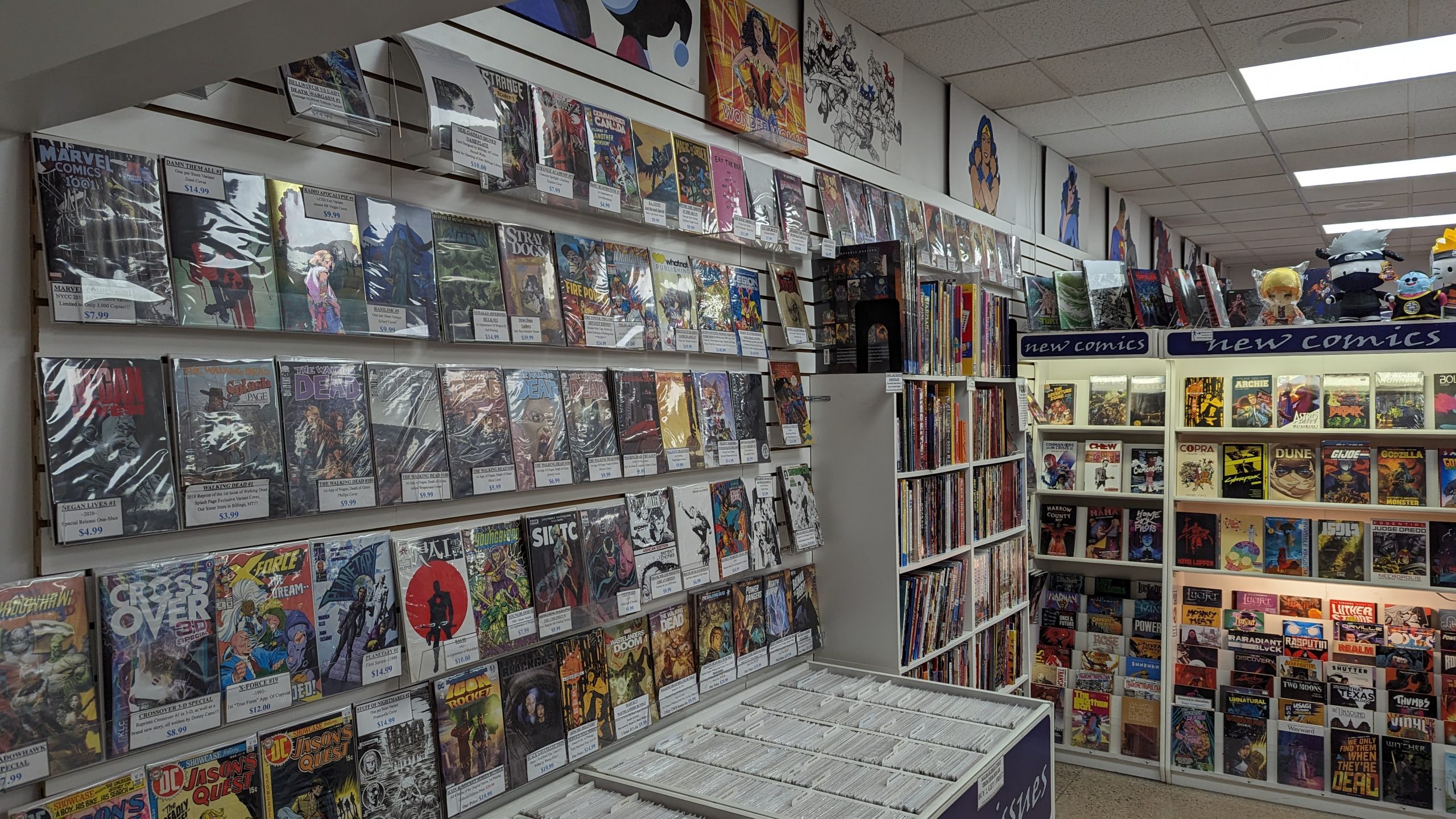 Wall of variant comic books, trade packerbacks, graphic novels and back issues at Muse Comics