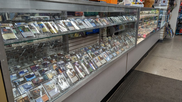 PXL_20221216_235533007 Magic the Gathering singles in a glass case